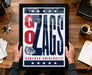 A framed poster with the text "GONZAGA UNIVERSITY" and a graphic of a bulldog is being held by a person's hands.