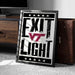 A framed poster with the text "EXIT LIGHT" and a Virginia Tech logo, placed on a carpeted floor next to a wooden chest.