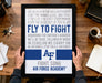 A framed poster with a motivational message about the Air Force, held by a person's hands.