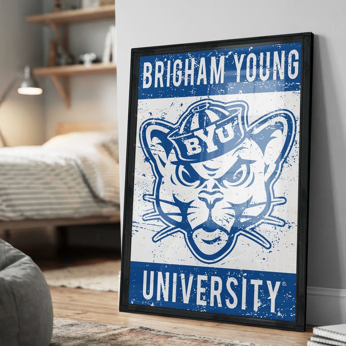 A framed poster of the University of Utah's mascot, a cat wearing a hat, is displayed on a wall in a bedroom.