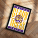 A framed poster with the text "GEAUX TIGERS" and a graphic of a tiger's head, placed on a wooden floor.