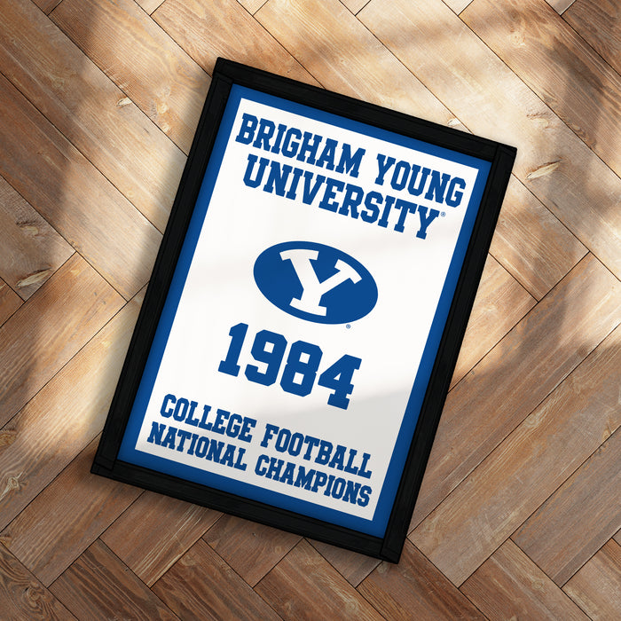 A framed poster with the text "BRIGHAM YOUNG UNIVERSITY" and "COLLEGE FOOTBALL NATIONAL CHAMPIONS" on it, along with a blue and white logo featuring a large "Y".