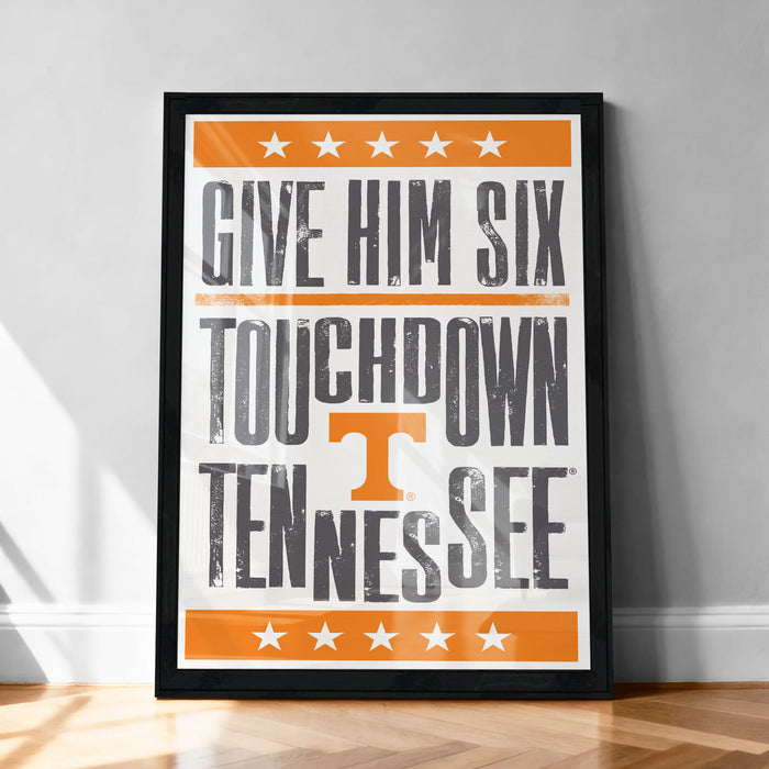 a framed poster with the text "GIVE HIM SIX TOUCHDOWN TENNESSEE" in bold, orange and black lettering.