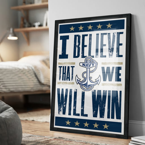 A framed poster with the text "I BELIEVE THAT WE WILL WIN" and an anchor symbol, placed on a wall in a room.