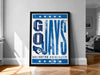 A framed poster with the text "GO JAYS" and the logo ofGREIGHTON UNIVERSITY, displayed on a wall in a room.