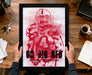 A framed poster featuring a football player in a red uniform, with the text "Go Big Red Nebraska Cornhuskers" printed on it.