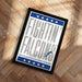 a framed poster with the text "FIGHTIN' FALCONS" and a lightning bolt symbol, placed on a wooden floor.