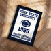 A framed poster with the text "Penn State University" and "1996 College Football National Champions" on it, celebrating the University's 1996 College Football National Champions victory.