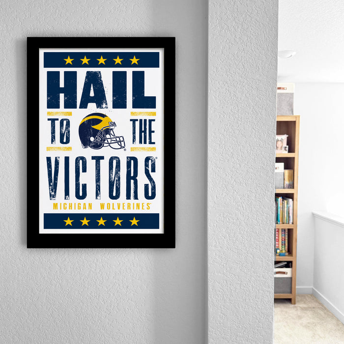 a framed poster with the text "Hail to the Victors" and a graphic of a football helmet, which appears to be a sports-themed poster.