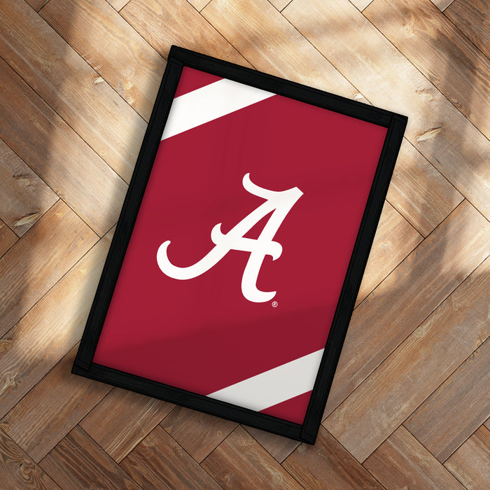 A framed poster with the letter "A" on it, placed on a wooden floor.