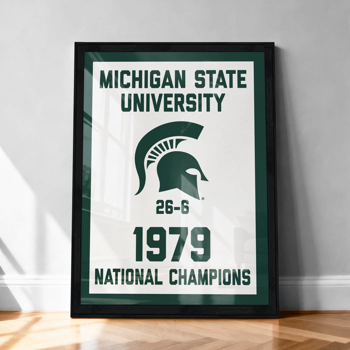 A framed poster celebrating the Michigan State University's 1979 National Champions, featuring the university's logo and the text "Michigan State University 1979 NATIONAL CHAMPIONS".
