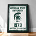 A framed poster celebrating the Michigan State University's 1979 National Champions, featuring the university's logo and the text "Michigan State University 1979 NATIONAL CHAMPIONS".
