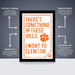 The image is a framed poster with the text "There's something in these hills. I went to college" and an orange paw print. The poster is described as " Officially licensed" and "Premium printed", indicating that it is a high-quality, professionally printed poster. The poster is also described as "Shipped flat" and "The perfect gift for the college student", suggesting that it is a thoughtful and practical gift for someone who is a college student.