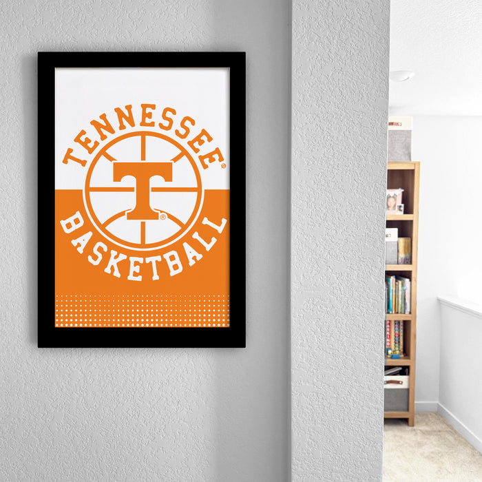 A framed poster of the Tennessee basketball team logo hangs on a wall, with a bookshelf visible in the background.
