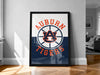 A framed poster of the Auburn Tigers logo is displayed on a wall in a room.