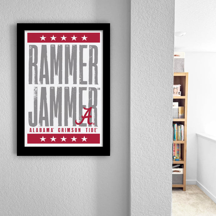 a framed poster with the text "RAMMER JAMMER" and "ALABAMA CRIMSON TIDE" printed on it, hanging on a wall.