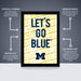 The image is a poster featuring the text "Let's go blue" in a bold, yellow font against a black background. The poster is described as " Officially licensed" and " Premium printed", indicating that it is a high-quality, professionally printed poster. The poster is also referred to as a "Shipped Flat" and "The perfect gift", suggesting that it is a thoughtful and practical present.