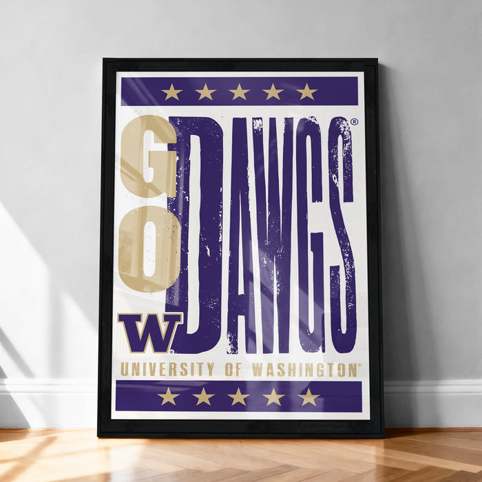 A framed poster with the text "GO DAVGS" and the University of Washington logo, placed on a wooden floor against a white wall.