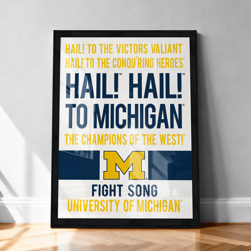 The image is a framed poster with text that reads "Hail! to the victors' champion! to michigan! the champions of the west! fight song university of michigan".