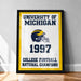 A framed poster with the text "UNIVERSITY OF MICHIGAN 1997 COLLEGE FOOTBALL NATIONAL CHAMPIONS" and a football helmet graphic, indicating that the University of Michigan was a College Football National Champion in 1997.