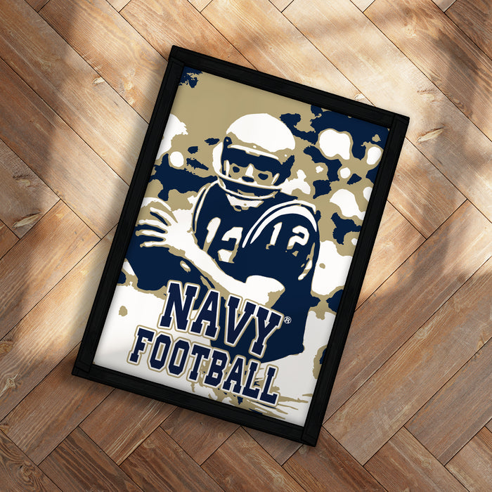 A framed poster featuring a football player in a navy uniform, with the text "NAVY FOOTBALL" prominently displayed.