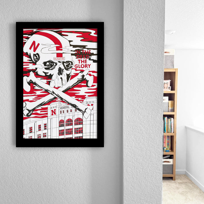 a framed poster with a skull and crossbones design, along with text that reads "HUSKERS IN THE GLORY".