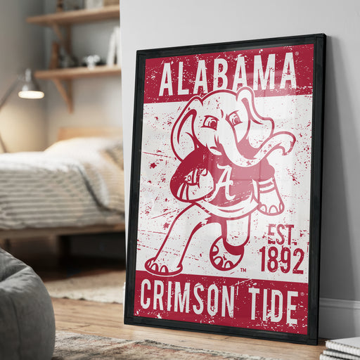 A framed poster of the Alabama Crimson Tide football team, featuring a cartoon elephant holding a football.