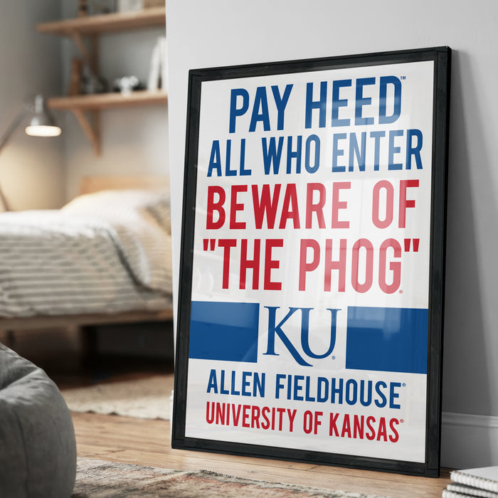 A framed poster with the text "PAY HEED ALL WHO ENTER BEWARE OF THE PHOG" and the logo of the University of Kansas Allen Fieldhouse.