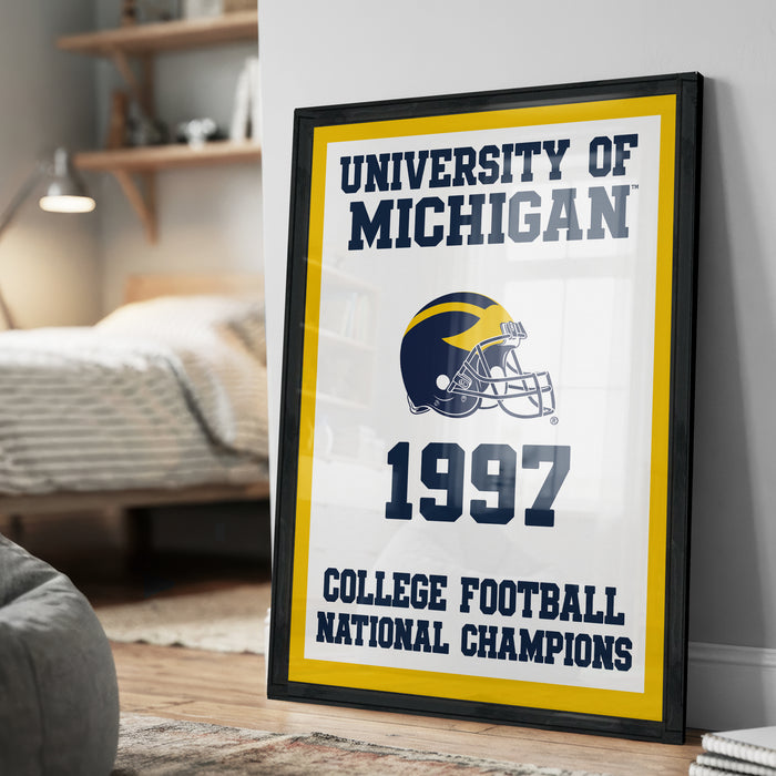 A framed poster on a wall celebrating the University of Michigan's 1997 College Football National Champions.