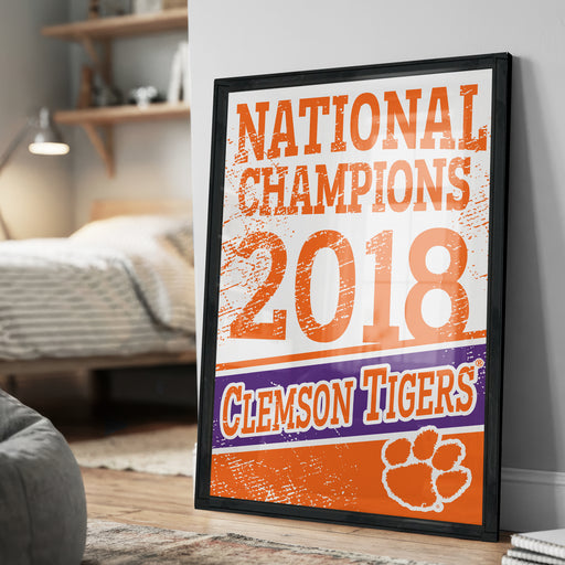 A framed poster celebrating the 2018 National Champions for the Clemson Tigers football team, with the team's logo and text prominently displayed.