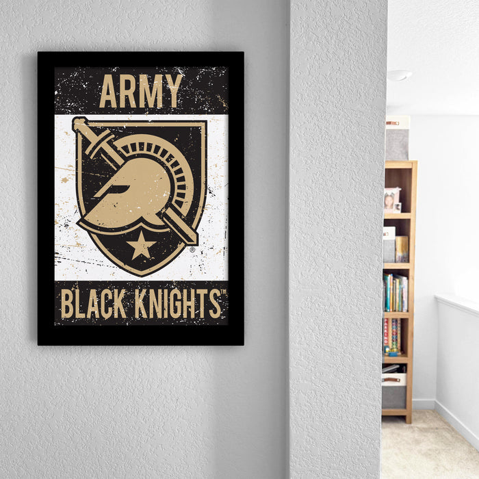 a framed poster of the Army Black Knights logo, which is a shield with a helmet and a sword, mounted on a wall.