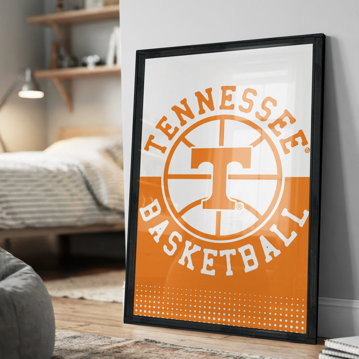 A framed poster of the Tennessee basketball team logo is displayed on a wall in a bedroom.