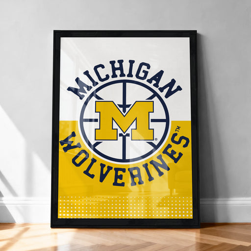 A framed poster with the text "Michigan Wolverines" and a logo, likely representing a sports team or organization.