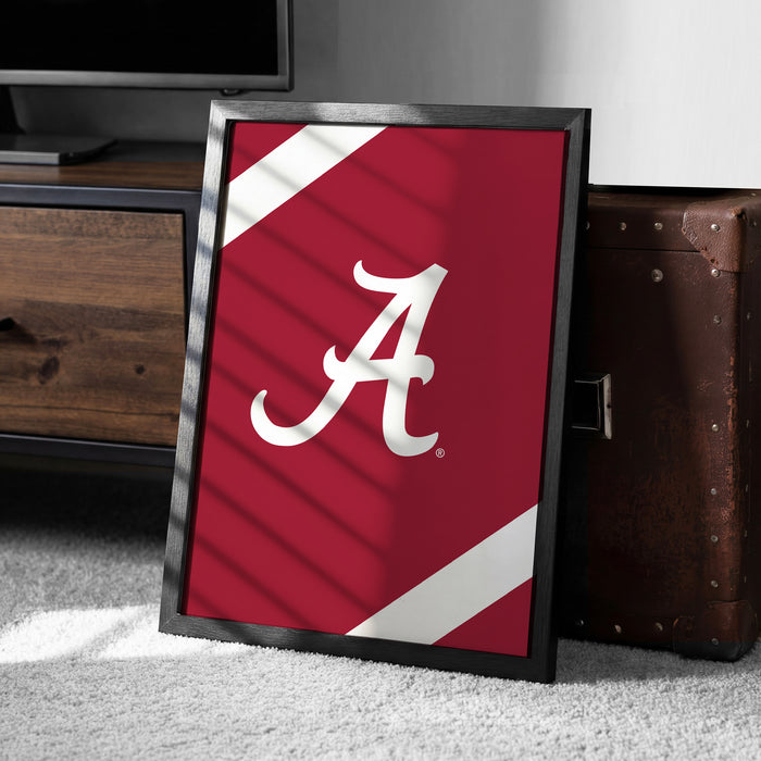 A framed poster with the letter "A" on it is placed on the floor next to a wooden chest.
