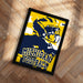A framed poster featuring a football player in a yellow and blue uniform, with the text "MICHIGAN FOOTBALL" displayed prominently.