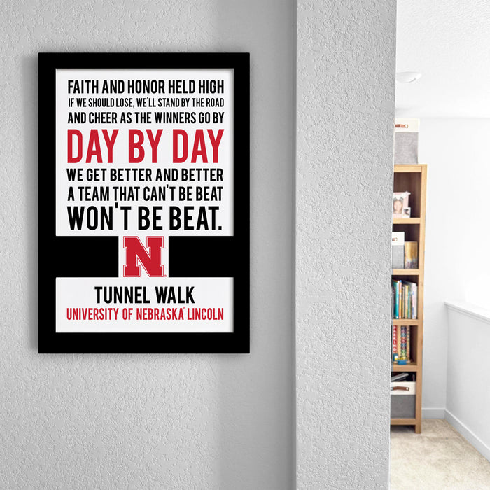 a motivational quote poster on a wall, with a bookshelf and a white wall in the background.