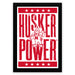 A framed poster with the text "HUSKER POWER" and a cartoon character, likely representing a sports team or brand.