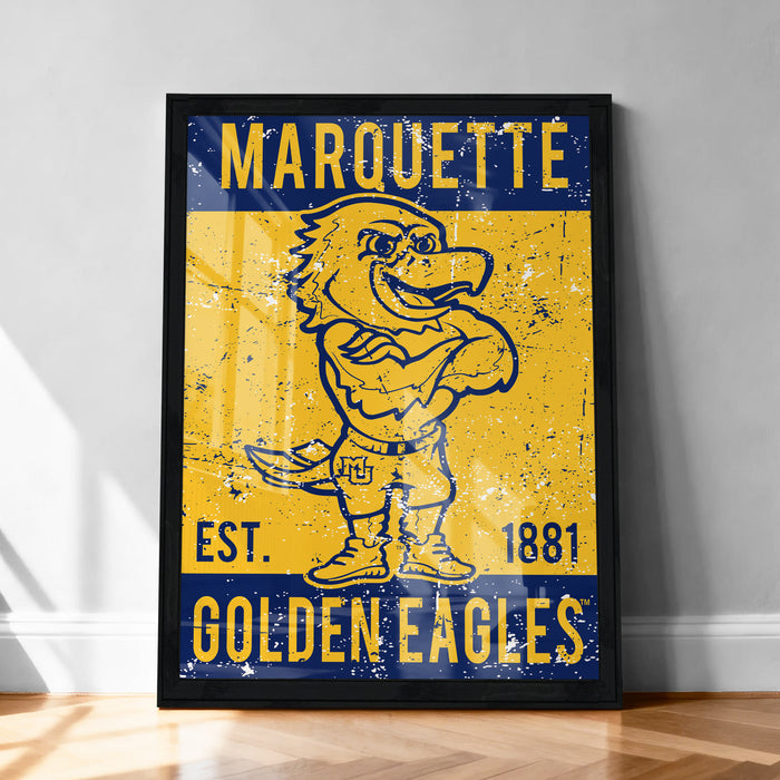 A framed poster featuring a cartoon eagle with the text "MARQUETTE EST. 1881 GOLDEN EAGLES" on it.