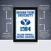 The image is a framed poster from Brigham Young University, featuring the year 1984 and the university's football team as the College National Champions. The poster is labeled as " Officially Licensed" and "Premium Printed", indicating that it is a high-quality, professionally printed poster. The poster is described as a "Shipped Flat" and "The Perfect Gift", suggesting that it is a thoughtful and attractive gift for someone who appreciates college sports and football.
