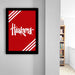 a framed poster with the word "Huskies" written on it, hanging on a wall.