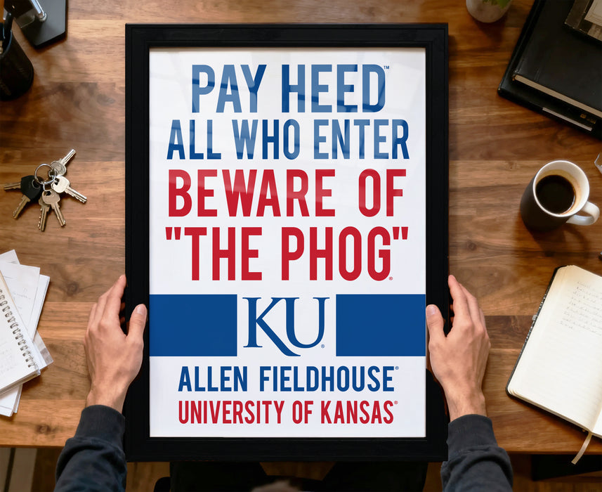 A framed sign with the text "PAY HEED ALL WHO ENTER BEWARE OF "THE PHOG" KU" from Allen Fieldhouse University of Kansas.