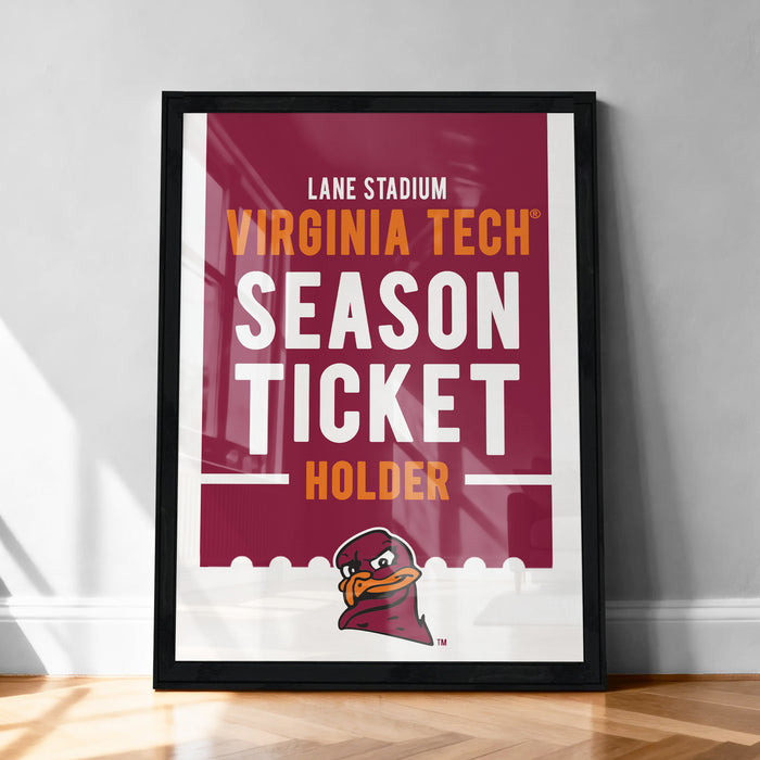 A framed poster advertising Virginia Tech's season ticket holder, with the text "LANE STADIUM VIRGINIA TECH SEASON TICKET HOLDER" prominently displayed.