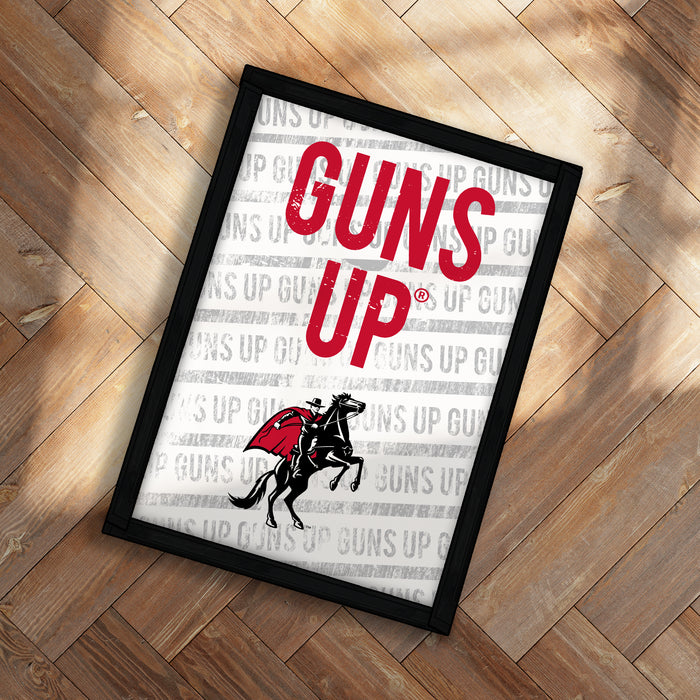 A framed poster with the text "GUNS UP" prominently displayed, along with a graphic of a person riding a horse.