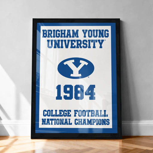 A framed poster celebrating the College Football National Champions of 1984, with the University of Utah logo prominently displayed.