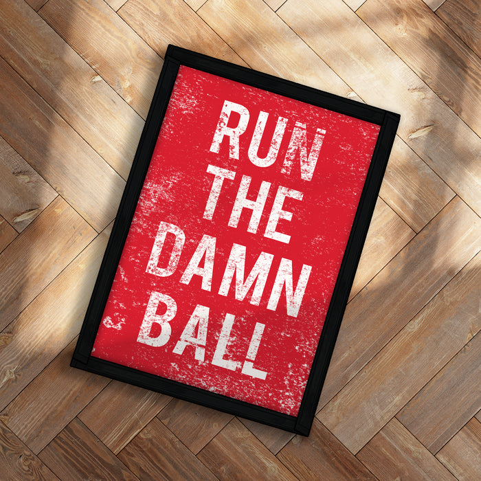 a red sign with the text "RUN THE DAMN BALL" in white letters.