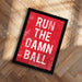 a red sign with the text "RUN THE DAMN BALL" in white letters.