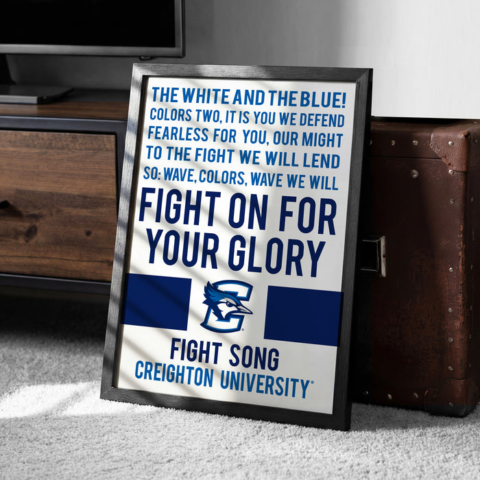 a framed poster with a motivational message about fighting for one's glory, placed on a carpeted floor next to a wooden chest.