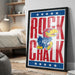 A framed poster featuring the text "ROCK CHALK" and an illustration of a bird, likely representing a sports team.