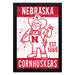 a red and white poster with the text "NEBRASKA CORNHUSKERS" and "EST. 1869". The poster also includes a cartoon character wearing a cowboy hat and holding a football.