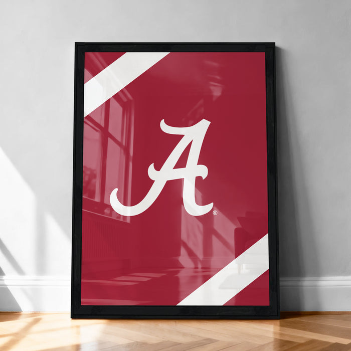 A framed poster with a large white "A" on a red background, placed on a wooden floor against a white wall.